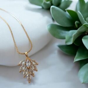 16ct gold plated leaf pendant filled with 8 sparkling cubic zirconia gems.